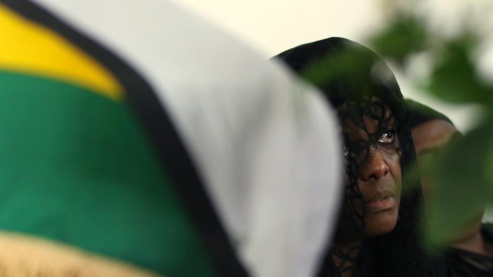 Grace Mugabe widow of former Zimbabwean President Robert Mugabe sits beside her husband"s coffin at their "Blue Roof" residence in Harare, Zimbabwe, September 12, 2019.