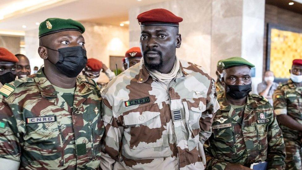 President of the National Committee for Rally and Development (CNRD) Colonel Mamady Doumbouya (C) leaves a meeting with high level representatives of the Economic Community of West African States (ECOWAS) in Conakry on September 17, 2021.