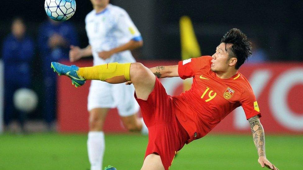 China's Zhang Xizhe kicks the ball during the World Cup football qualifying match between China and Uzbekistan in Wuhan in China's central Hubei province on August 31, 2017