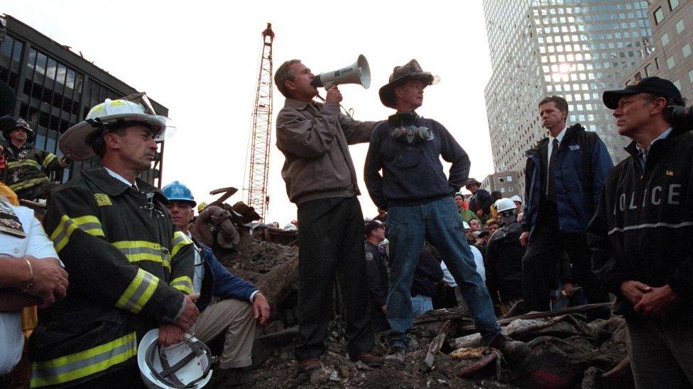 President George W Bush speaks to firefighters and rescue workers at the site of the collapsed World Trade Center.