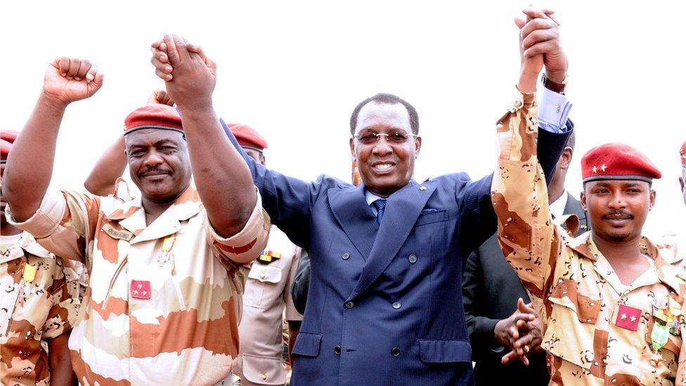 Chad's President Idriss Deby Itno (C) holds hands with General of the Chadian contingent in Mali Oumar Bikimo (L) and second-in-command major and his son Mahamat Idriss Deby Itno (R) during a welcome ceremony, on May 13, 2013, in N'Djamena.