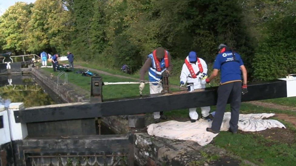 volunteers painting a lock