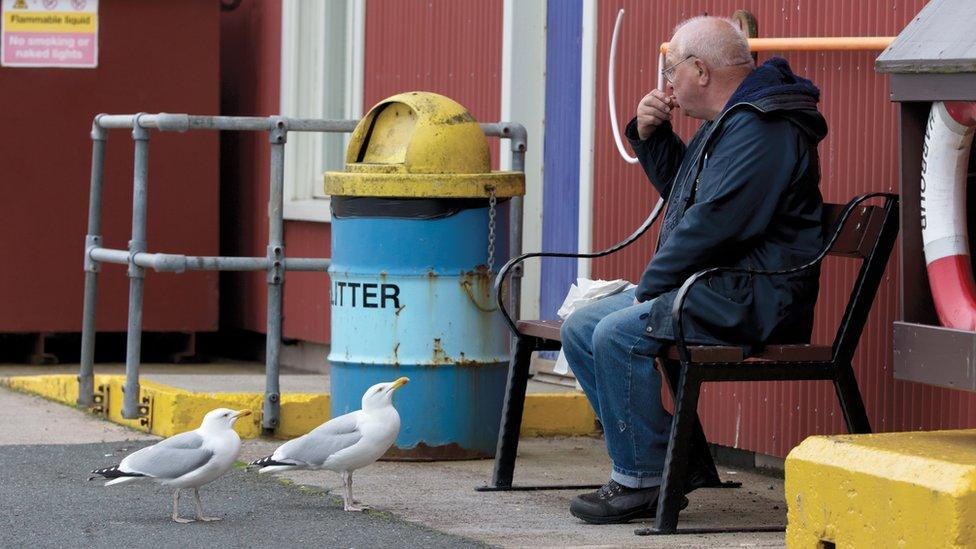 Man eating chips at seaside