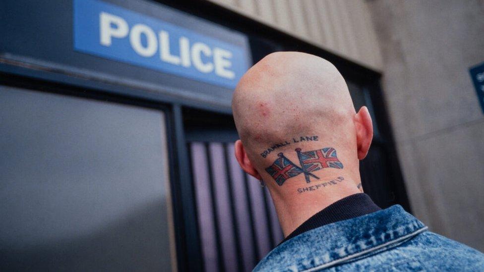 A man stands outside a police station