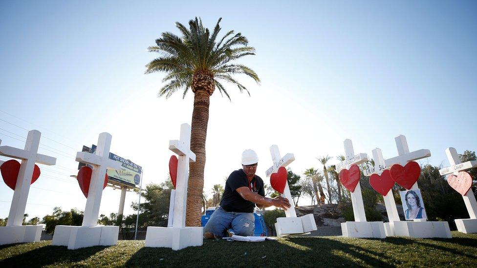 Greg Zanis works on one of the 58 white crosses he set up for the victims of the Route 91 music festival mass shooting in Las Vegas