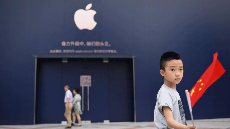 Boy outside an Apple store