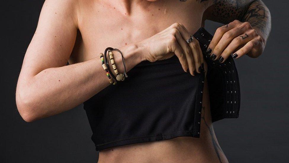 A model fitting a chest binder