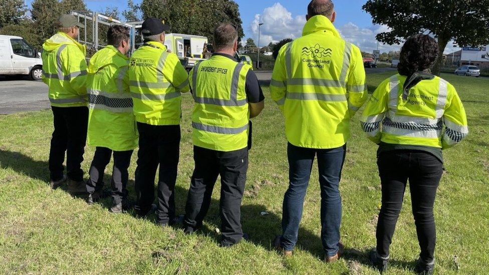 Officers in high-visibility jackets