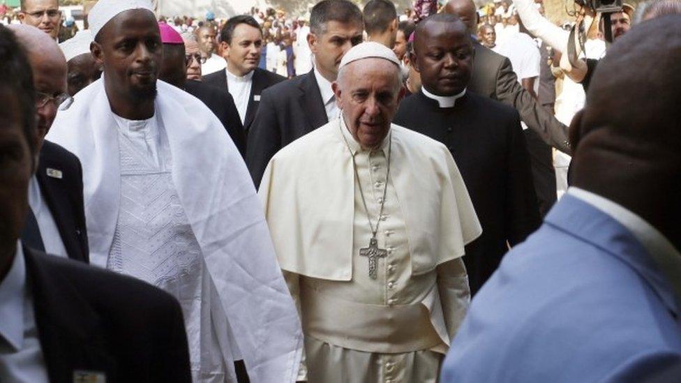 Pope Francis is welcomed by Imam Tiding Moussa Naibi, left, on the occasion of his visit at the Central Mosque in Bangui"s Muslim enclave of PK5, Monday Nov. 30, 2015