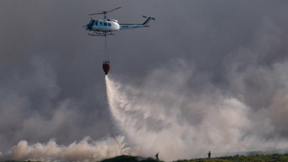 helicopter dropping water