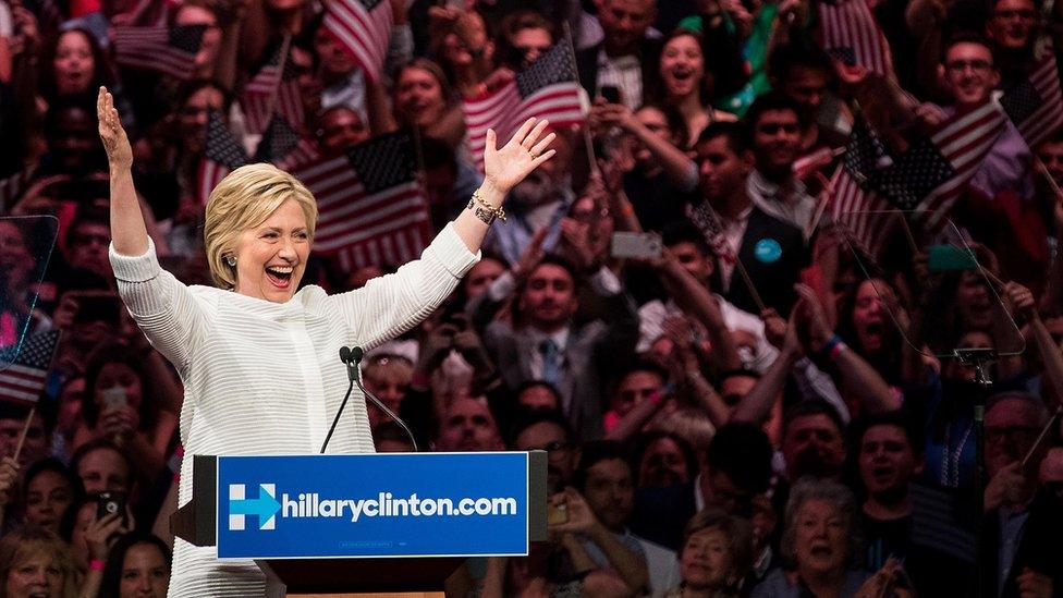 Hillary with her arms up high during a rally