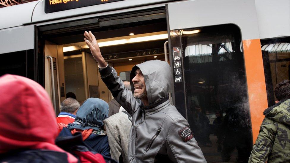 A number of migrants board a train along with other passengers as they head out of Copenhagen Central Station 10 September 2015 for the Swedish border