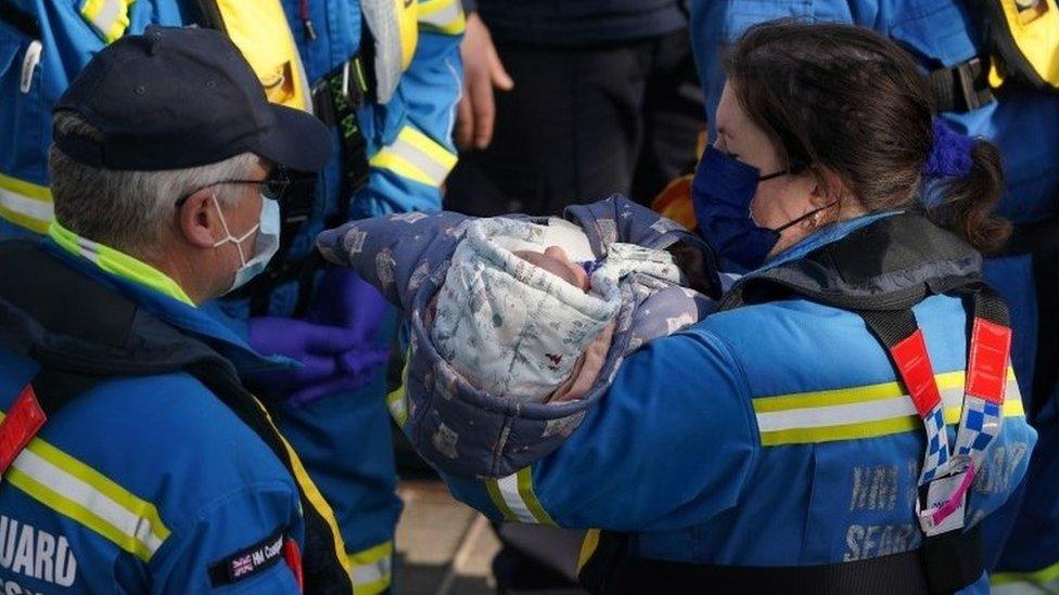 Baby being brought ashore