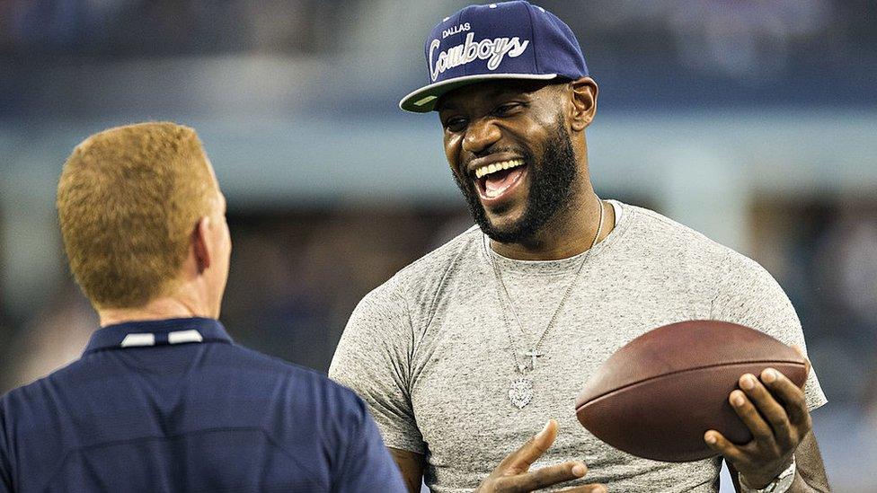 LeBron James holding an American football