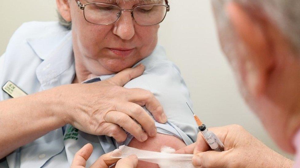 A nurse looks on after receiving the AstraZeneca COVID-19 vaccine at the Camp Hill Medical Center in Brisbane, Australia, 22 March 2021.