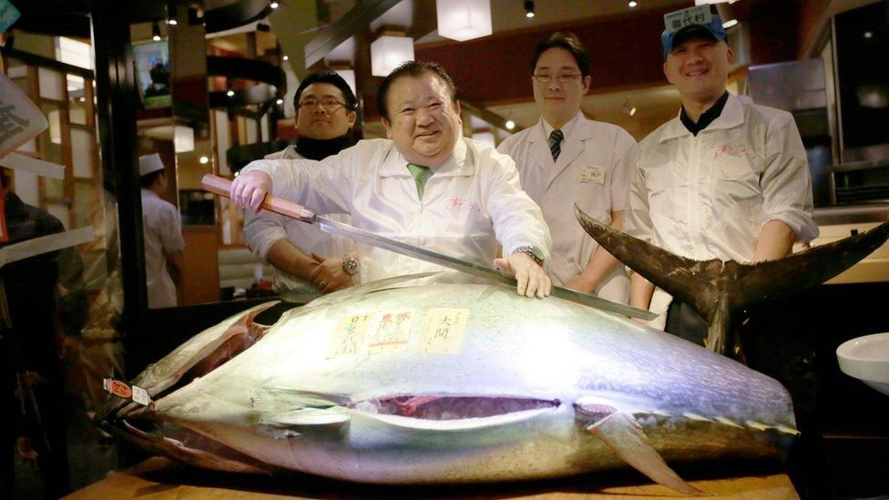 Kiyoshi Kimura and staff pose with the tuna he won in the auction, at his Sushi Zanmai restaurant near the market