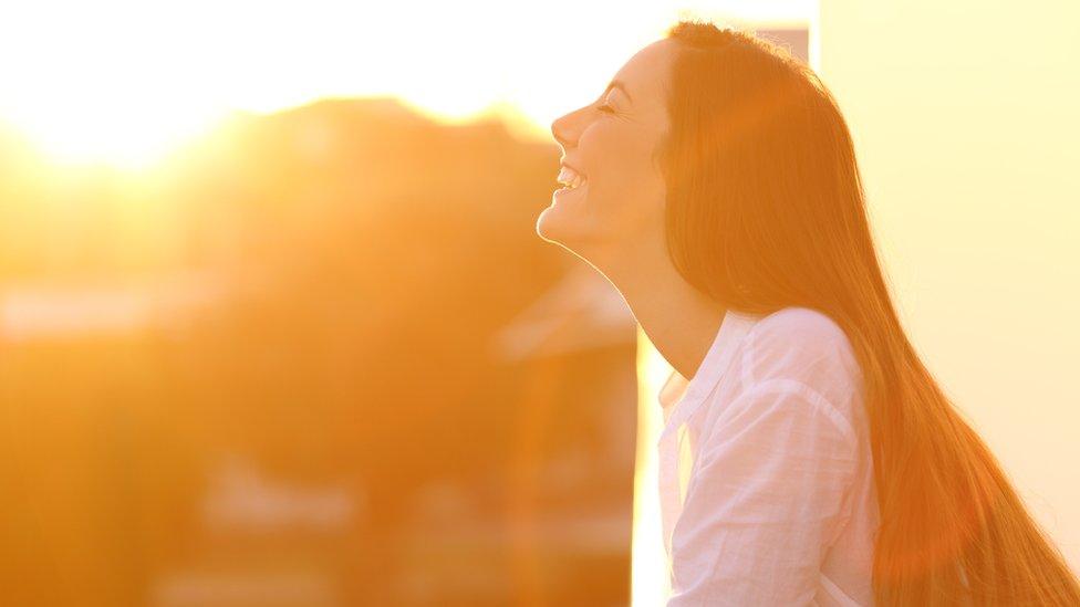 Woman in strong sunshine