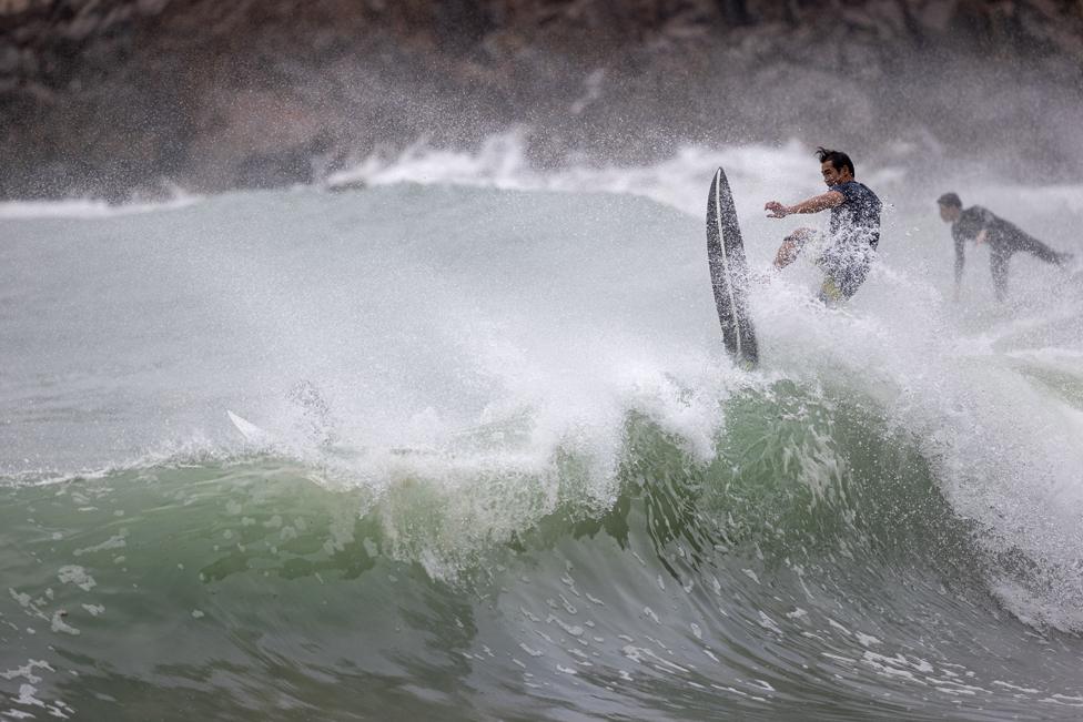 A man surfs on waves brought by typhoon Nesat in Big Wave Bay, Hong Kong, China, 17 October 2022.