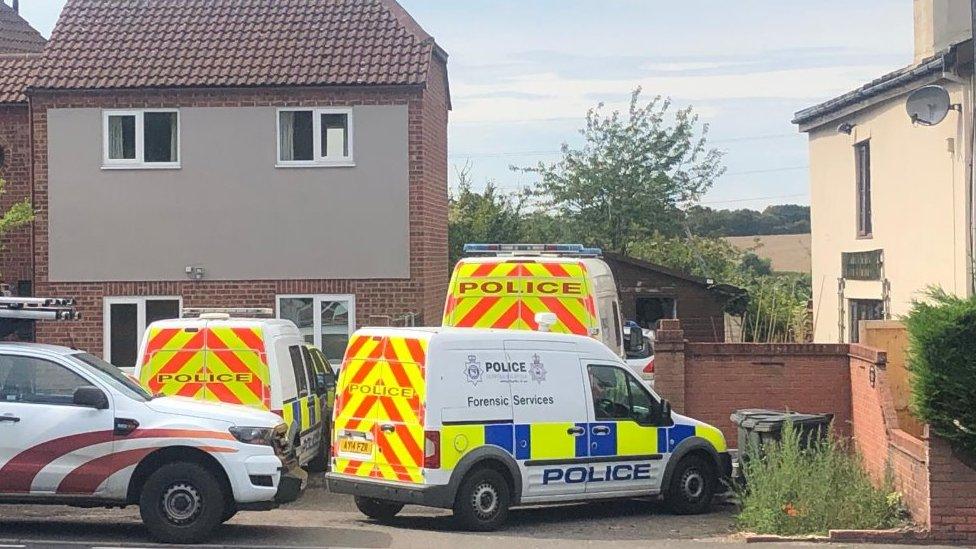 Police vehicles outside where police found a cannabis factory in Earl Stonham