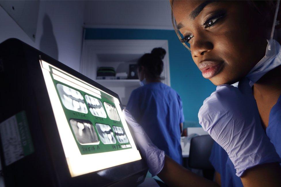 Dentist looking at X-ray of teeth