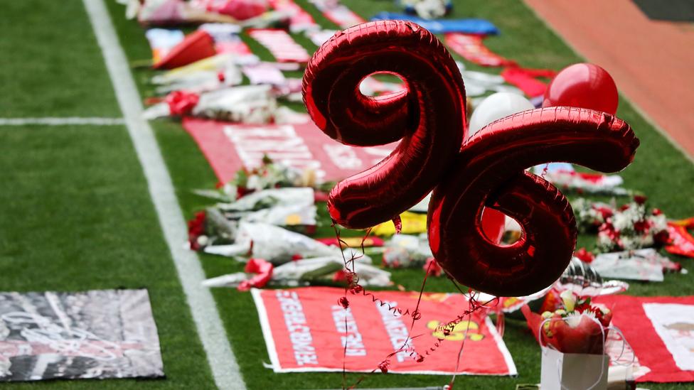 Tributes are placed on the pitch before a memorial service to mark the 27th anniversary of the Hillsborough disaster, at Anfield stadium on April 15, 2016 in Liverpool, England.