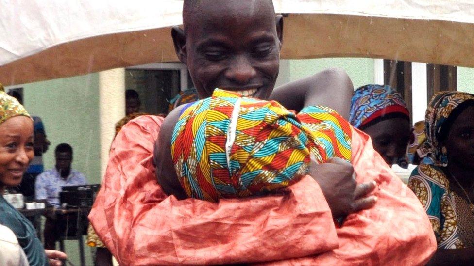 One of the kidnapped girls celebrates with a family member during an church survives held in Abuja, Nigeria