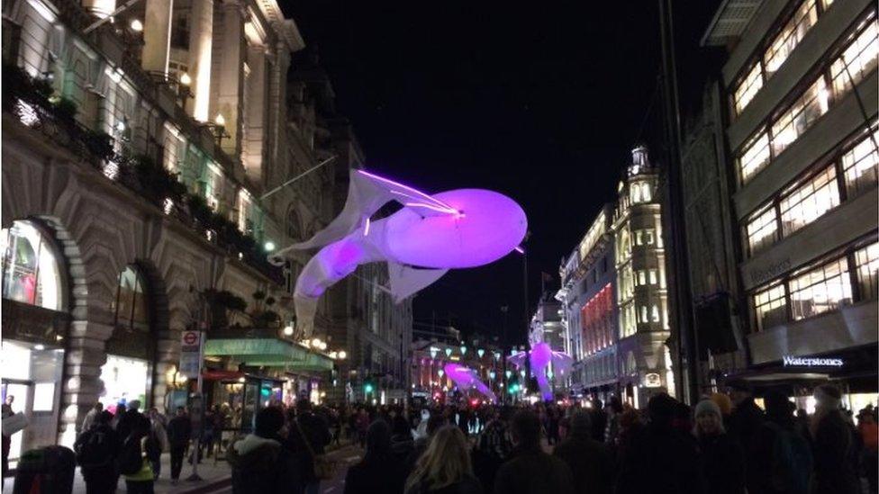 The illuminations over the crowds in Piccadilly