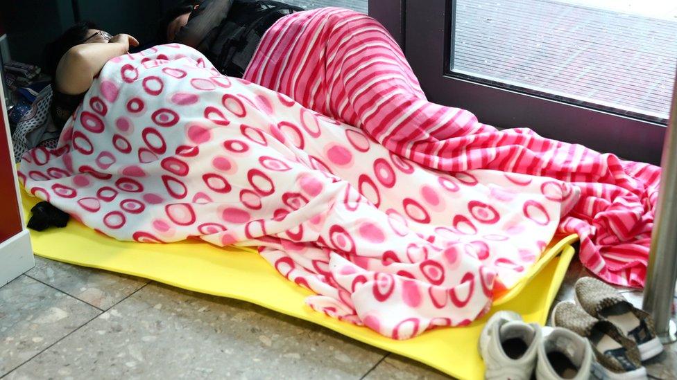 People sleep at Heathrow Terminal 5 in London