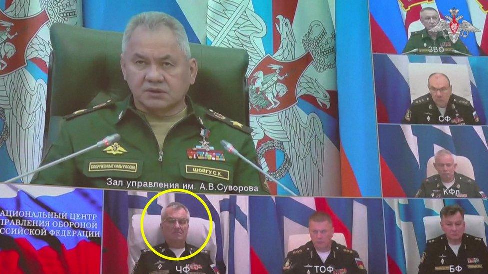 Still from footage shows video link with Defence Minister Sergey Shoygu on big screen and Adm Sokolov immediately below him