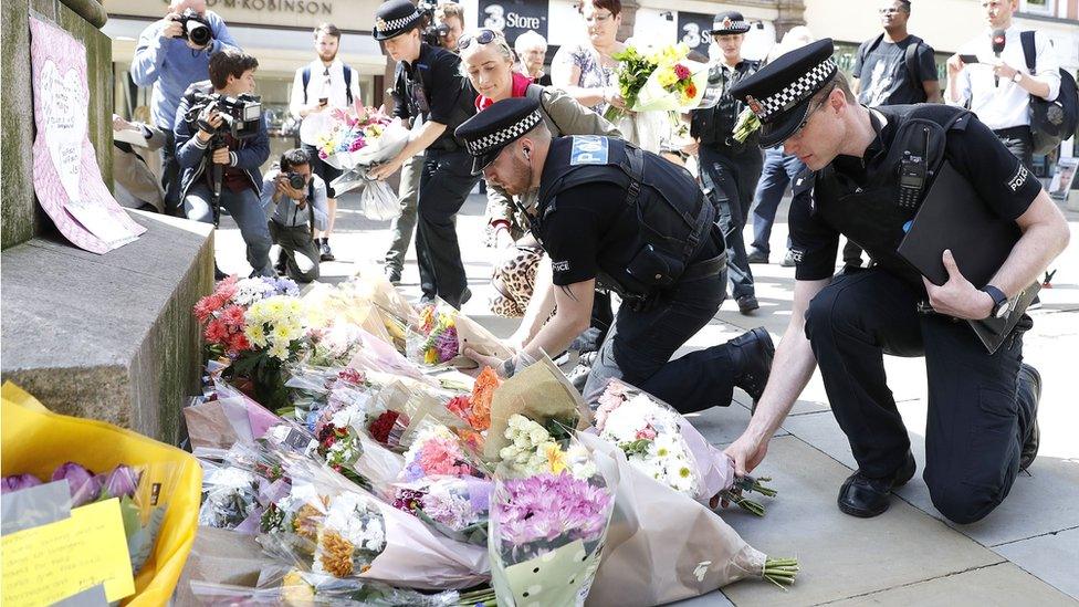 Police laying flowers in Manchester