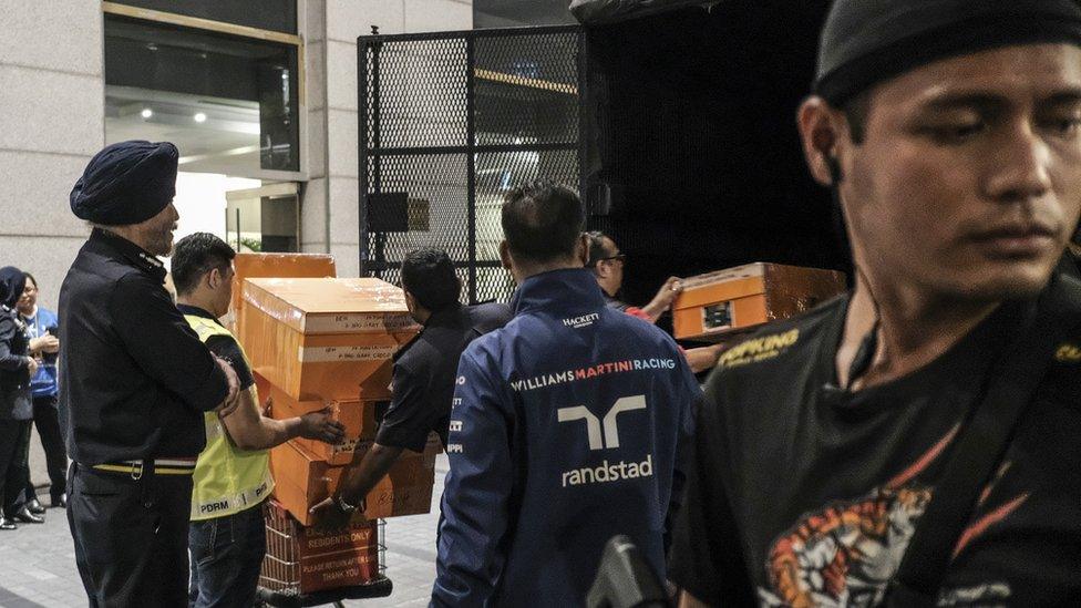 Boxes loaded into a truck by police officers in Kuala Lumpur, Malaysia