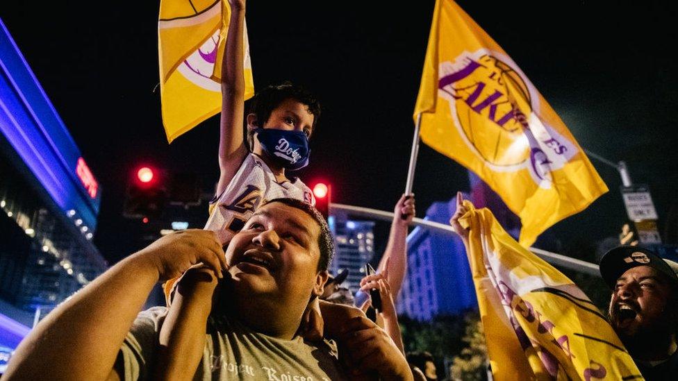 LA Lakers fans celebrating at their home stadium, the Staples Center