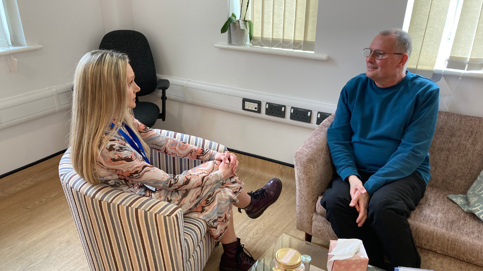 Mandy Scott sitting with Duncan Pike at PEDS' Peterborough Office