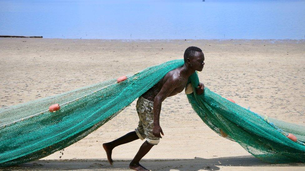 A fisherman pulls a net on the main beach on March 8, 2018 in Mocimboa da Praia, Mozambique.