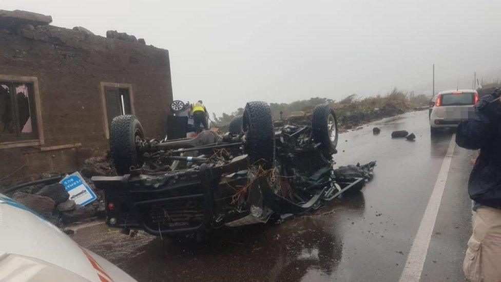 An overturned car on a road on the island of Pantelleria