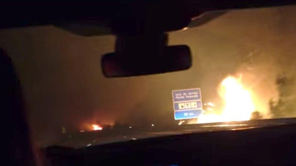 Flames from a forest fire are seen next the A17 road near Paiao, Portugal 16/10/2017