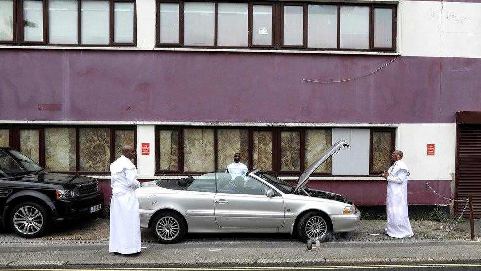 Worshippers bless a vehicle