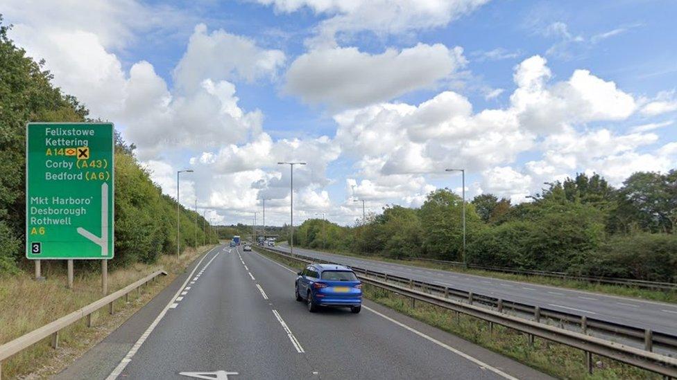 Two-lane carriageway showing junction 3 sign