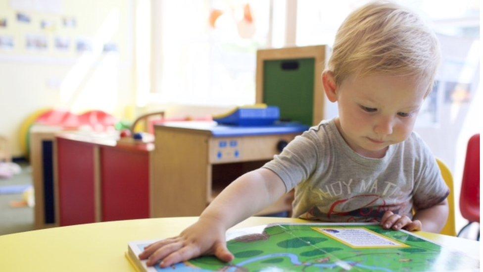 A young boy reads a book