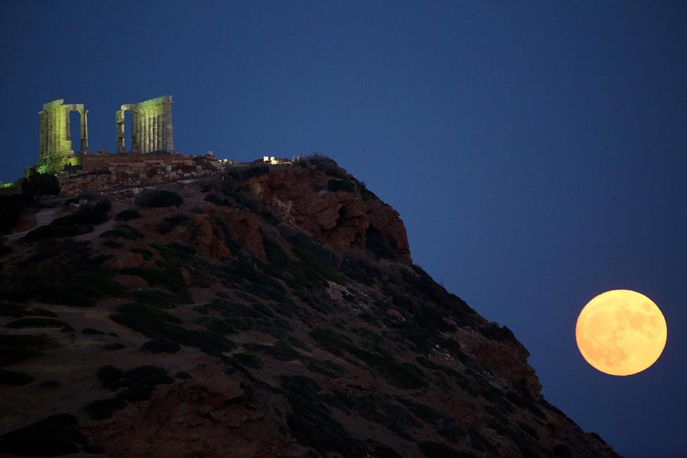 The moon rises over Cape Sounio and the Temple of Poseidon, east of Athens