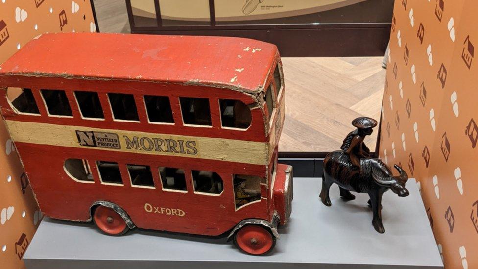 Model bus and carved water buffalo