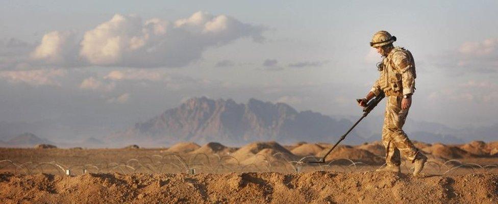 A British soldier sweeps for IEDs in Afghanistan