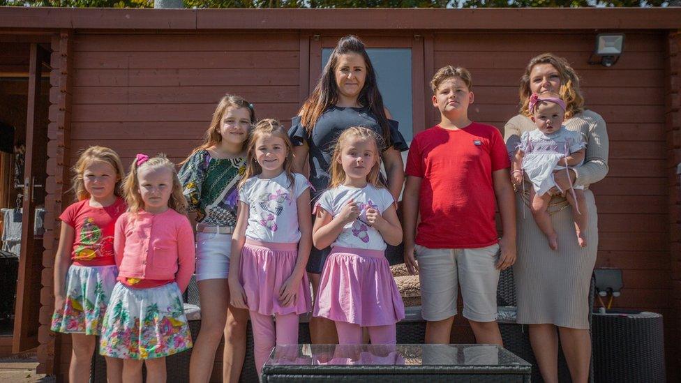 Charlotte and Gemma surrounded by the children who live on the land