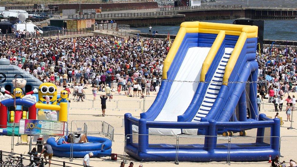 A girl, aged three, was thrown off the blue bouncy trampoline, pictured in front of the slide