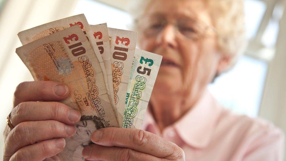 Pensioner holding money