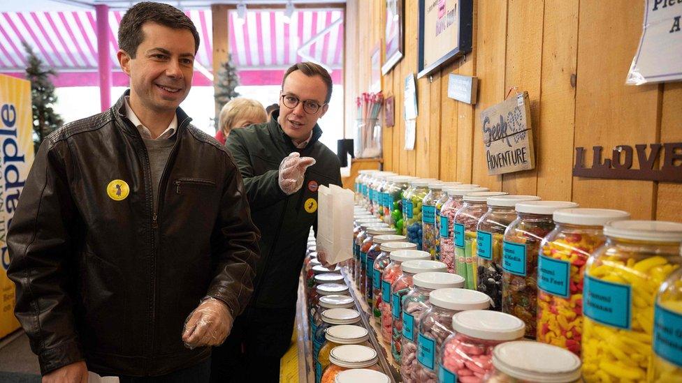 Democratic presidential hopeful Pete Buttigieg and his husband Chaster (R) visits a sweet shop in Littleton, New Hampshire on 10 November 2019