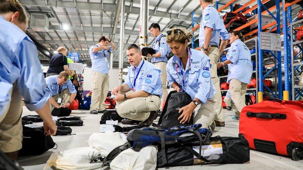 The Australian medical team packing their bags in a hangar prior to departure to Christmas Island