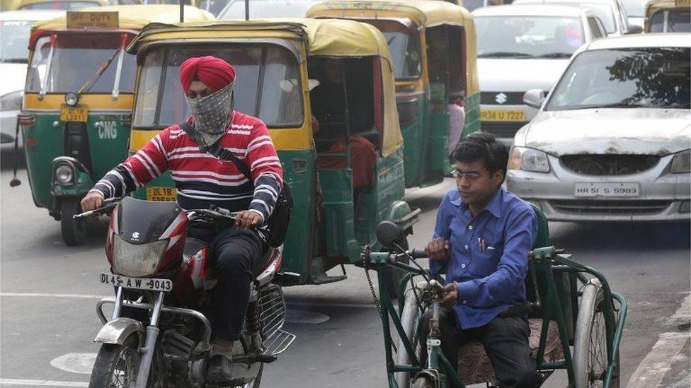 An Indian Sikh man uses a handkerchief as protective mask against the smog as he rides a mototcycle in a busy street of New Delhi, India, 08 December 2015.