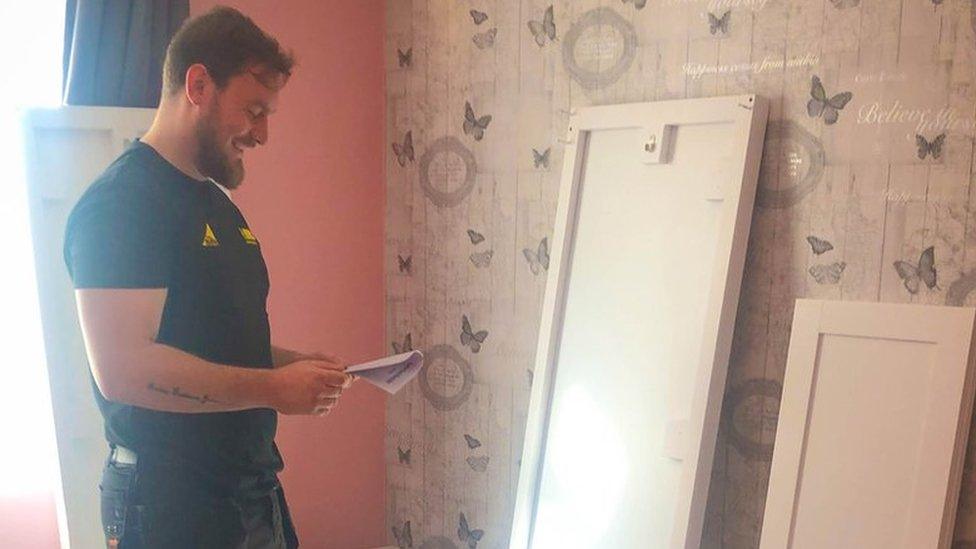 A man helping to renovate a bedroom