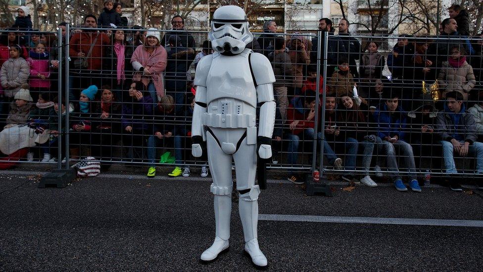 A man dressed as a Stormtrooper waits for the start of the Three Kings parade in Madrid in 2016.